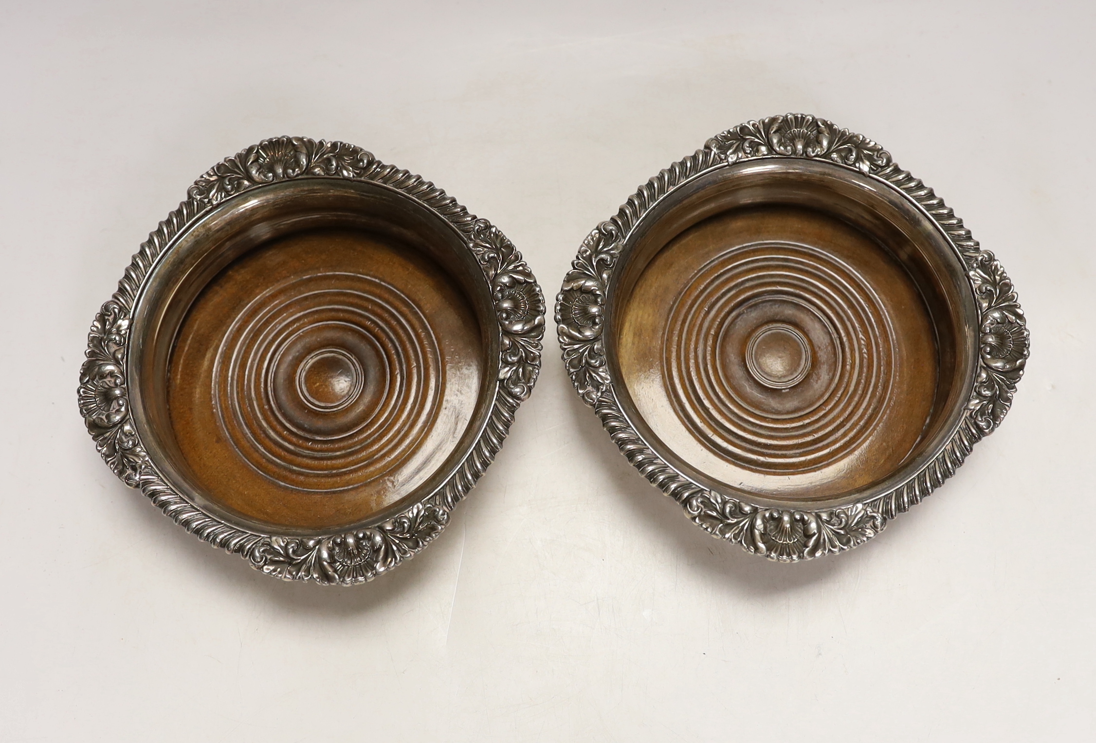 A pair of Victorian silver plated wine coasters, 17cm in diameter